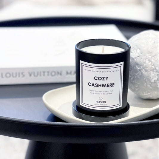 Cozy Cashmere coconut soy candle in matte black jar with almond, cardamom and sandalwood scent, hand poured in Canada.