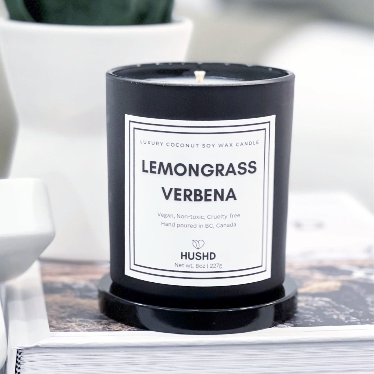 Experience our luxury scented coconut soy candle with wild lemongrass, verbena and jasmine petals in a matte black jar.
