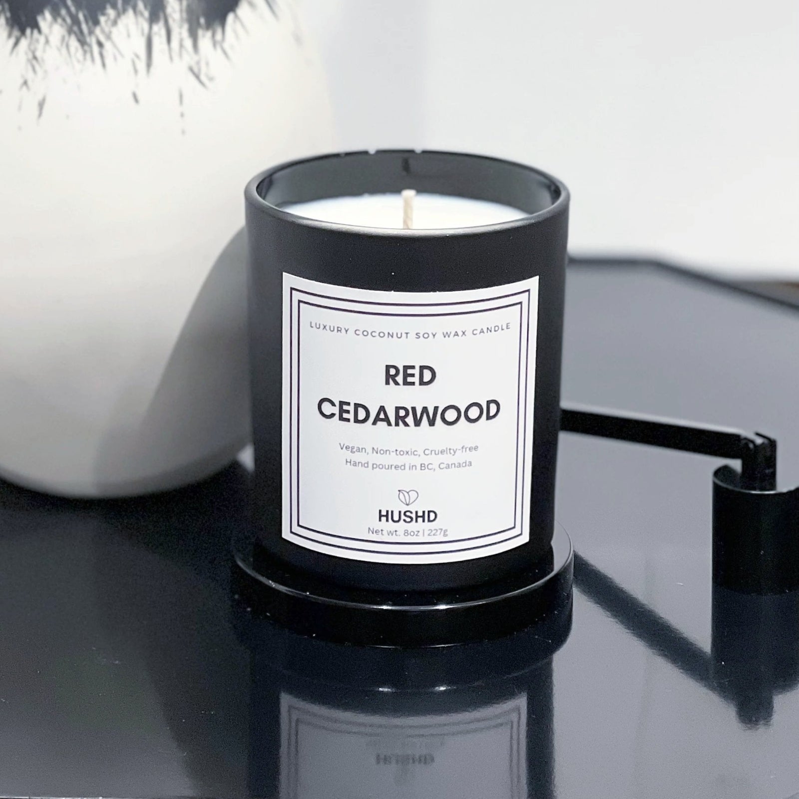 Red Cedarwood coconut soy candle in matte black jar with masculine cedar aroma, hand poured in Canada, shop now.